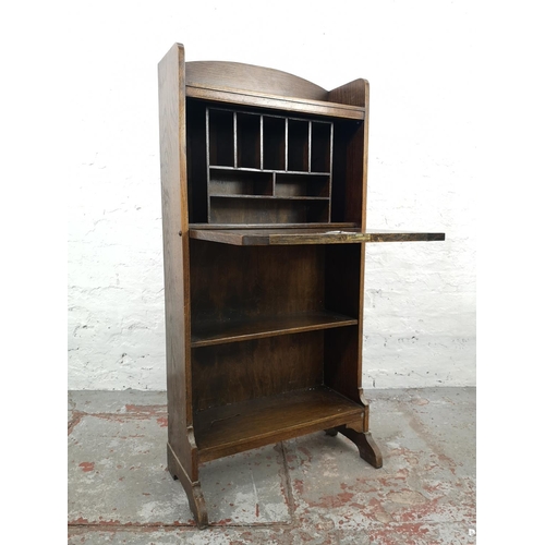 54 - An early/mid 20th century oak bureau with fall front and two lower shelves - approx. 118cm high x 56... 