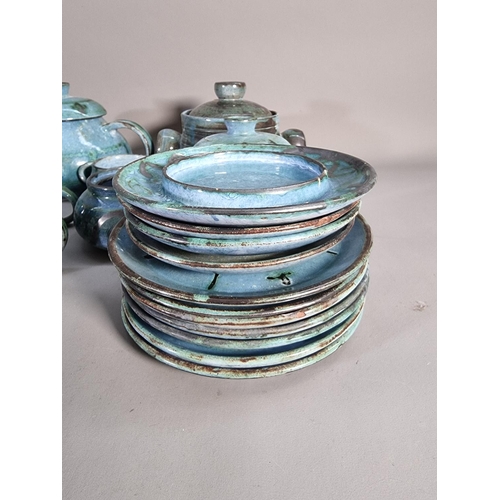 1206 - A large collection of blue glazed studio pottery signed 'B' to base comprising teapot, coffee cups, ... 