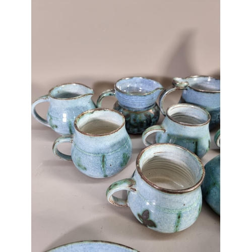 1206 - A large collection of blue glazed studio pottery signed 'B' to base comprising teapot, coffee cups, ... 