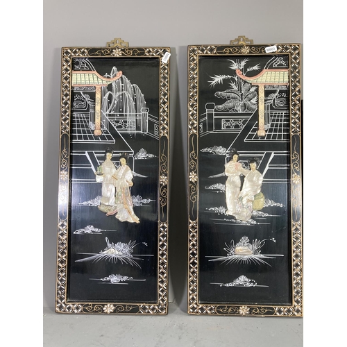 1418 - Three Oriental black lacquer and mother of pearl panels, two - approx. 60cm x 25cm and one - approx.... 