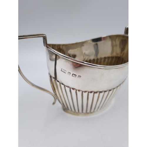 1034 - An Edwardian Joseph Gloster Ltd hallmarked Birmingham silver three piece tea set with gadrooning bor... 