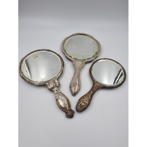 1035 - Three antique sterling silver hand mirrors - largest approx. 29cm long x 16cm diameter