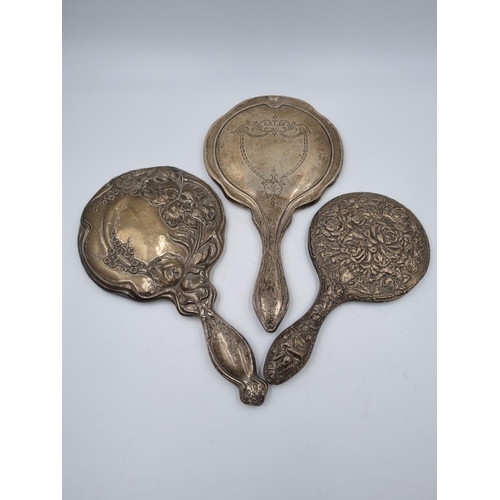 1035 - Three antique sterling silver hand mirrors - largest approx. 29cm long x 16cm diameter