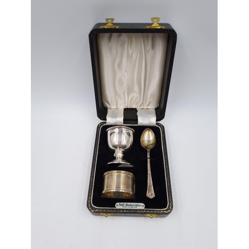 1037 - A boxed hallmarked Birmingham silver three piece Christening set comprising filled egg cup, napkin r... 