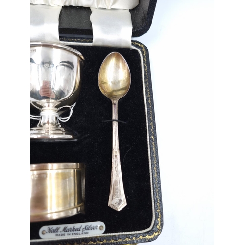 1037 - A boxed hallmarked Birmingham silver three piece Christening set comprising filled egg cup, napkin r... 