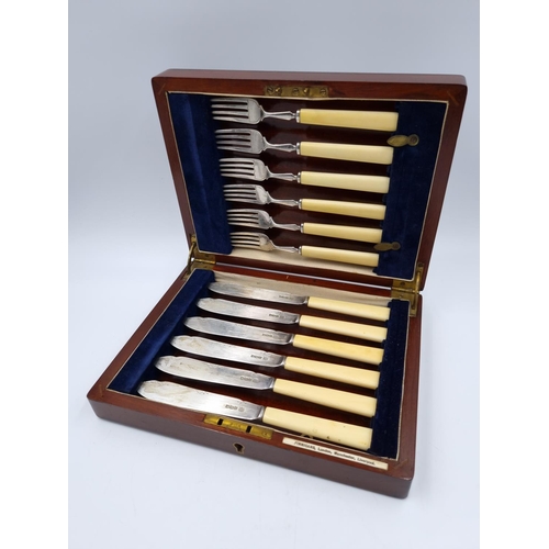 1039 - A Finnigans mahogany cutlery case containing twelve hallmarked Sheffield silver fish knives and fork... 