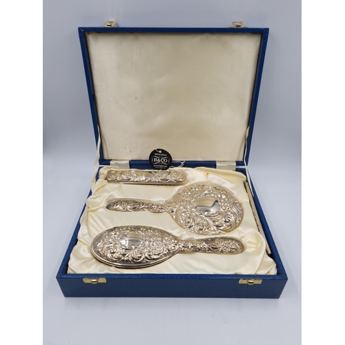 1040 - A boxed as new Broadway & Co Ltd hallmarked Birmingham silver three piece dressing table set, dated ... 