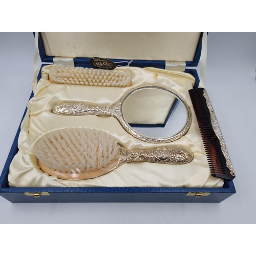 1040 - A boxed as new Broadway & Co Ltd hallmarked Birmingham silver three piece dressing table set, dated ... 