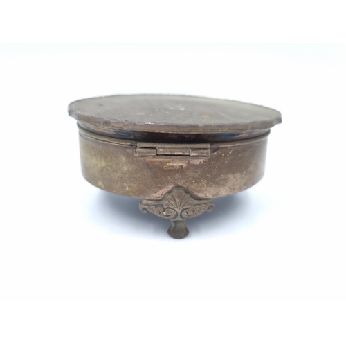 1047 - A vintage white metal circular tri footed trinket box with serial no. 830519 - approx. 9cm diameter ... 