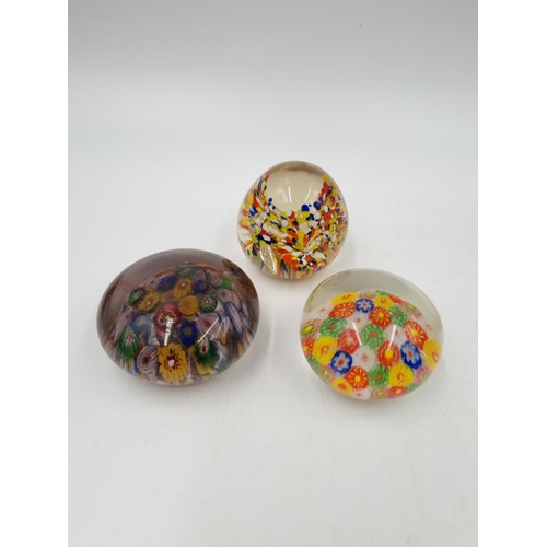 1125 - Eight assorted art glass paperweights to include Mdina, Caithness Streamers, Millefiori etc.