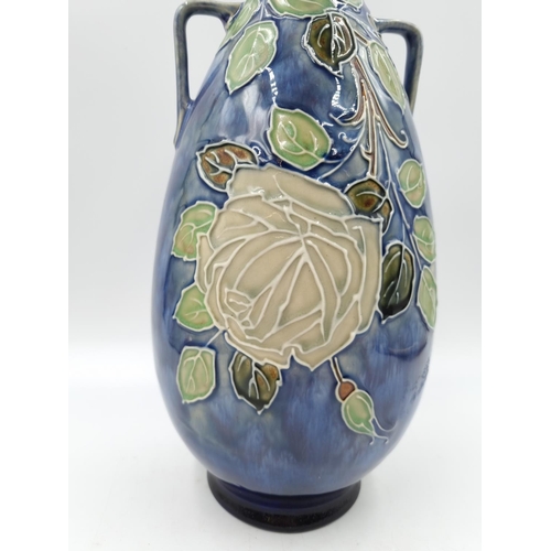 1131 - A late 19th/early 20th century Royal Doulton vase with tube lined rose design - approx. 29cm high