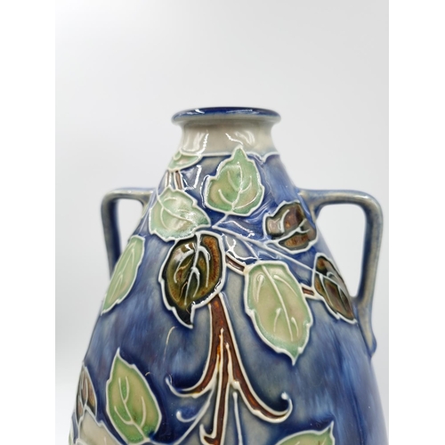 1131 - A late 19th/early 20th century Royal Doulton vase with tube lined rose design - approx. 29cm high