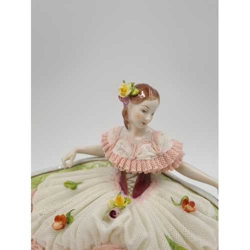 1140 - A Volkstedt porcelain lace figurine of lady on bench - approx. 14cm high x 18cm wide