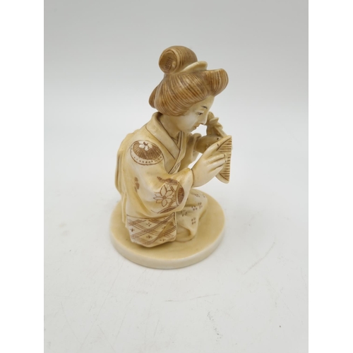 1145 - An Oriental ivory porcelain figurine of a Geisha girl - approx. 9.5cm high