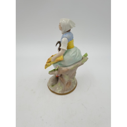 1146 - A German porcelain figurine of a girl with wheatsheaf - approx. 12cm high