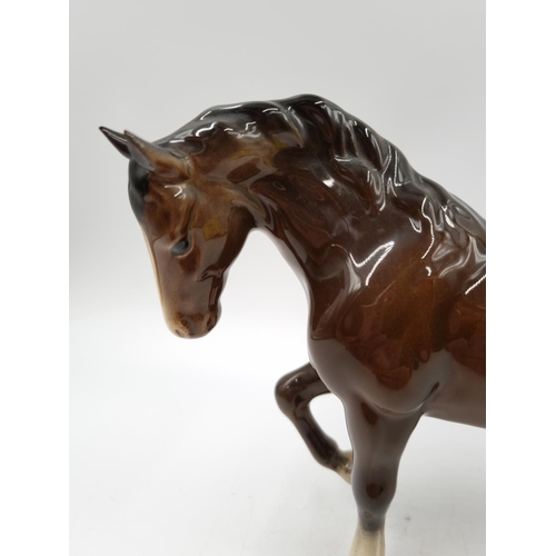 1166 - A Beswick brown horse figurine - approx. 15cm high x 22cm long