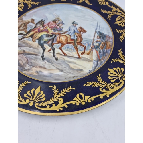 1203 - A Sevres style hand painted porcelain plate with gilt decoration, cobalt blue ground, cavalry scene ... 