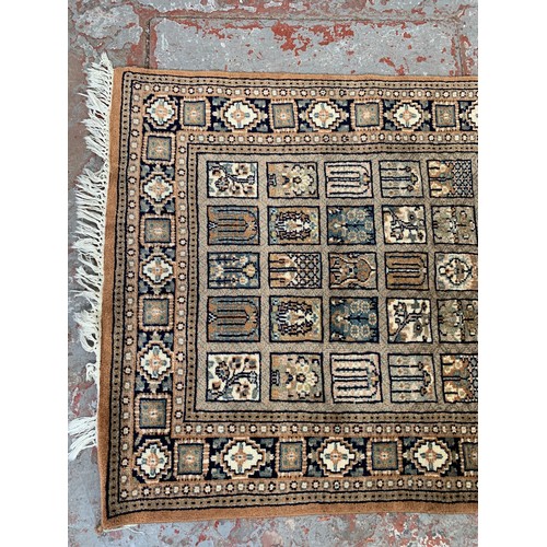 247 - A Persian style brown rug - approx. 160cm x 94cm