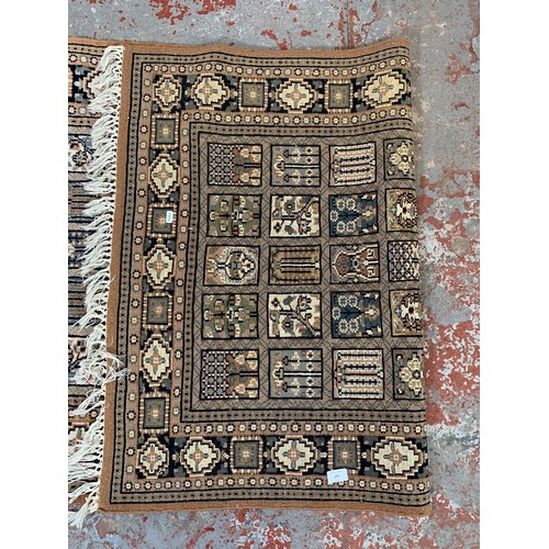 247 - A Persian style brown rug - approx. 160cm x 94cm