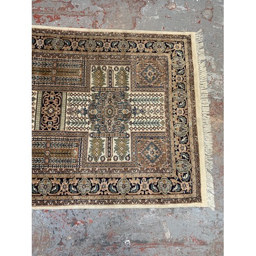 248A - A Persian style brown and cream rug - approx. 215cm x 126cm