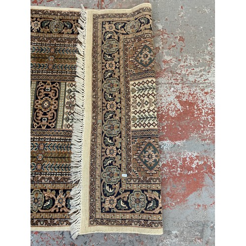 248A - A Persian style brown and cream rug - approx. 215cm x 126cm