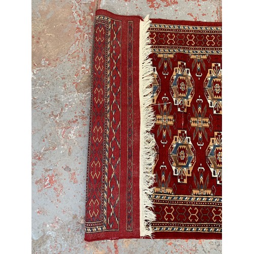 249 - A Persian style red rug - approx. 200cm x 120cm