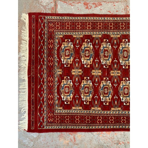 249 - A Persian style red rug - approx. 200cm x 120cm