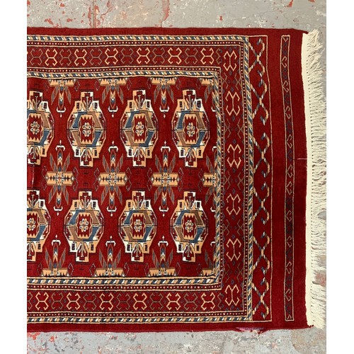 249 - A Persian style red rug - approx. 200cm x 120cm