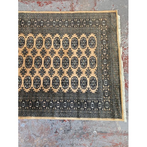 253 - A Persian style brown rug - approx. 193cm x 128cm