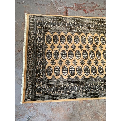 253 - A Persian style brown rug - approx. 193cm x 128cm