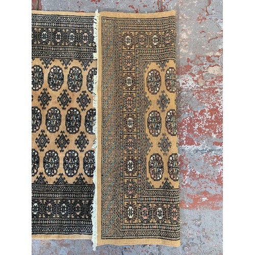 253 - A Persian style brown rug - approx. 193cm x 128cm