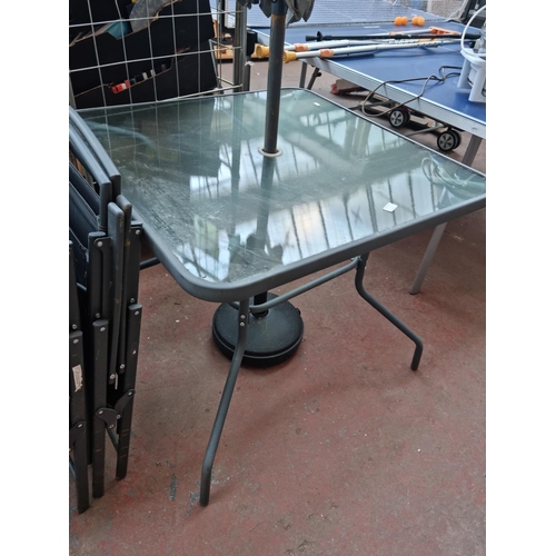 520E - A grey metal six piece patio set comprising square glass topped table - approx. 72cm high x 86cm squ... 