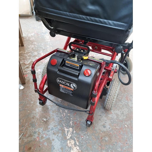 520F - An UltraLite electric mobility chair with two battery packs, battery charger and owners manual