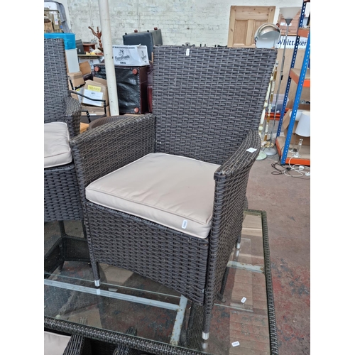 520A - A plastic rattan effect and glass rectangular patio table with six matching chairs - approx. 73cm hi... 