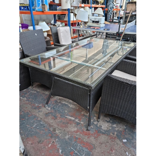 520A - A plastic rattan effect and glass rectangular patio table with six matching chairs - approx. 73cm hi... 