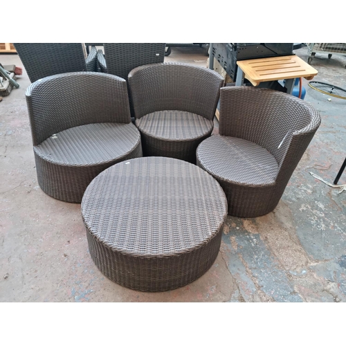 520B - A plastic rattan effect circular four piece patio set comprising three tub chairs and coffee table