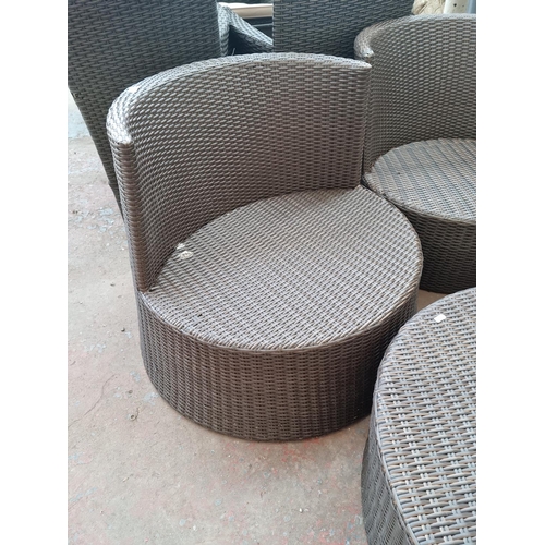 520B - A plastic rattan effect circular four piece patio set comprising three tub chairs and coffee table