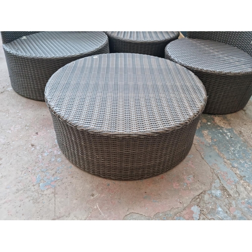 520B - A plastic rattan effect circular four piece patio set comprising three tub chairs and coffee table