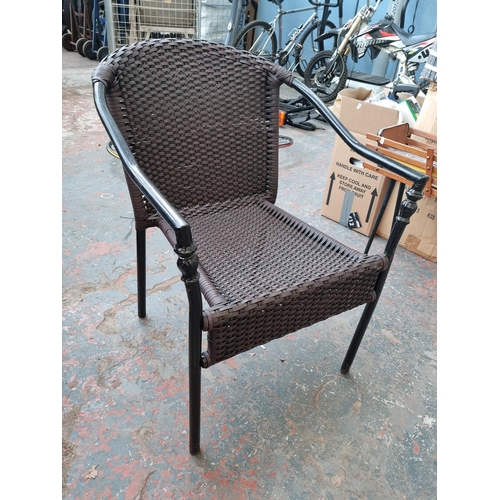 520C - A pair of rattan and black metal garden armchairs