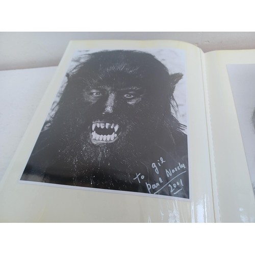 396 - A photo album containing signed film photographs.