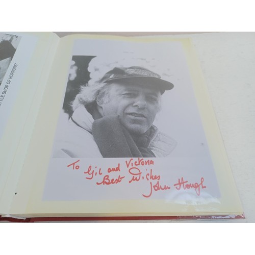 396 - A photo album containing signed film photographs.