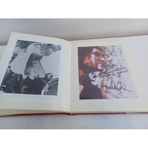 396 - A photo album containing signed film photographs.