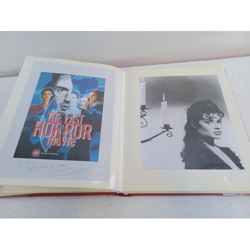 396 - A photo album containing signed film photographs.