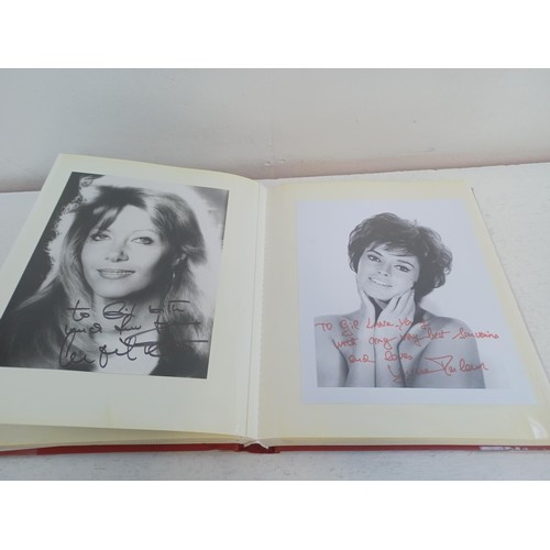 396 - A photo album containing signed film photographs.