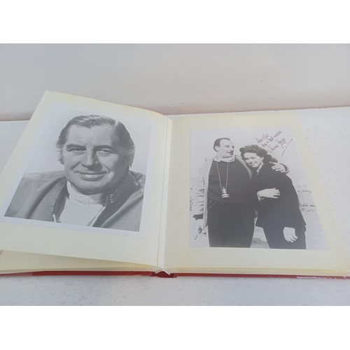 396 - A photo album containing signed film photographs.