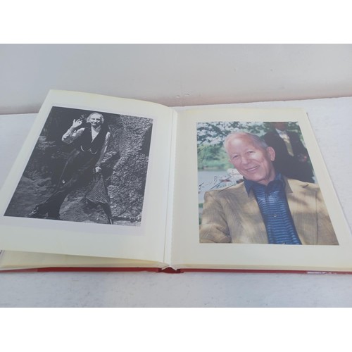 396 - A photo album containing signed film photographs.