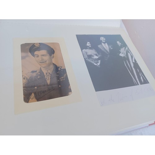 396 - A photo album containing signed film photographs.