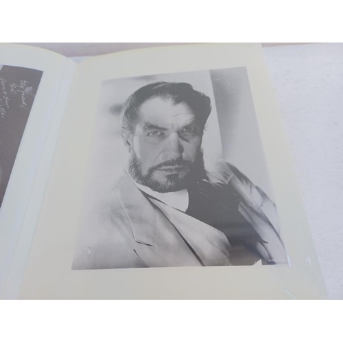 396 - A photo album containing signed film photographs.