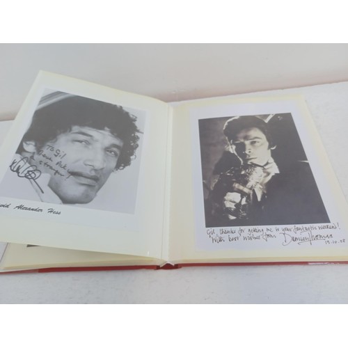 396 - A photo album containing signed film photographs.