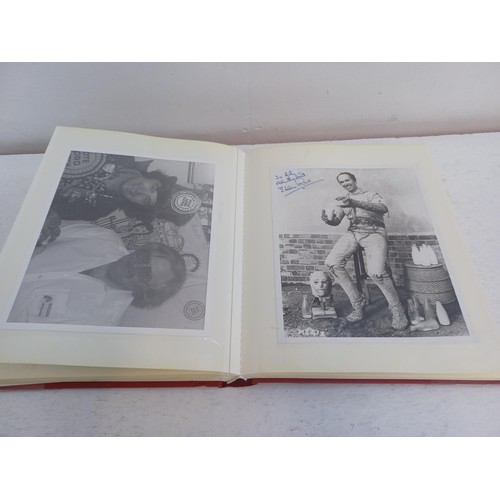 396 - A photo album containing signed film photographs.